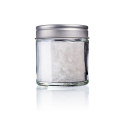 sea salt in a glas with metal lid, isolated on white