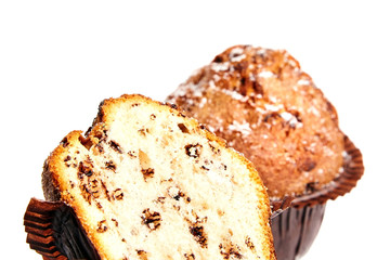 Half and whole muffin with chips of chocolate and powdered sugar, isolated on white background. Selective focus