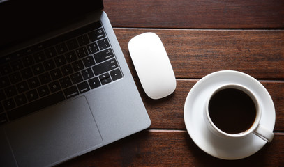 Office table with Laptop,mouse,Hot coffee Top view, flat lay