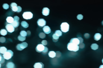 Fototapeta premium Glowing light bulbs in the blur, bokeh. New Year's lights, color background, Christmas mood.