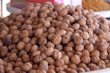 Heap whole walnuts forsale at a nuts and dried fruits shop.