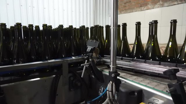 Bottling and sealing conveyor line at winery factory