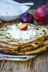Big stack of pancakes with blueberries and raspberries