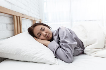 Fototapeta na wymiar Beautiful Attractive Asian woman sleep and sweet dream on bed in bedroom in the morning feeling so relax and comfortable,Healthcare Concept