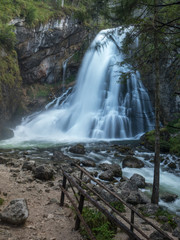 Obraz premium View of famous Gollinger Wasserfall with mossy rocks and green trees on a moody in springtime, Golling, Salzburger Land, Austria. August, 2018
