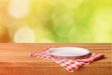 White Plate on napkin on wooden table