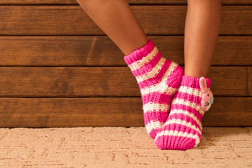 Funny pink socks on the legs of a little girl