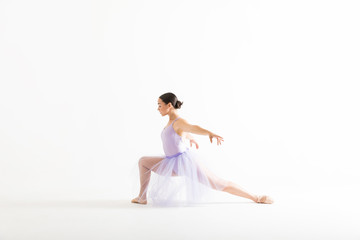 Fototapeta na wymiar Graceful Ballet Dancer Posing Against White Background