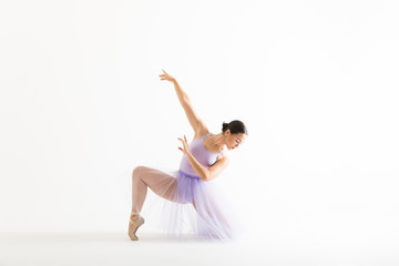 Fototapeta na wymiar Beautiful Woman In Ballet Costume Practicing Over White Background
