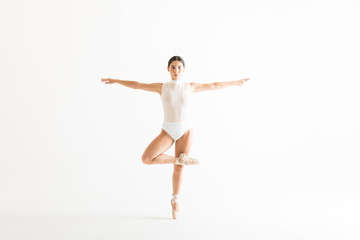 Confident Ballerina With Arms Outstretched Standing On One Leg