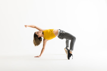 Woman Arching Back While Break Dancing Over White Background