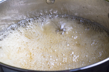 Boiling liquid in pot close up - Cooking caramel sugar syrup at fast boil