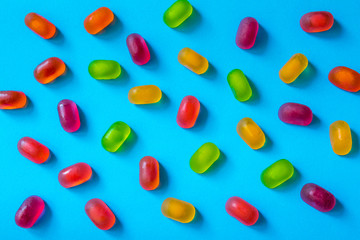 Colorful  jelly candy pattern on a blue background, top view