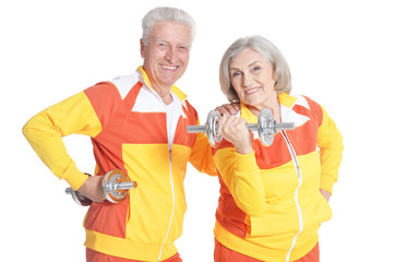 Portrait of active smiling senior couple doing exercise