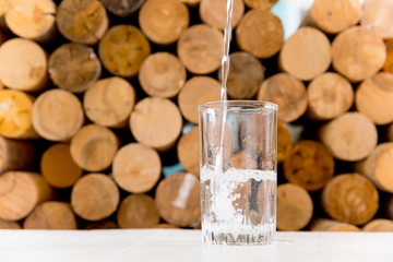 Glass of pure water on a white kitchen table