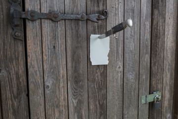 Knife holdng a note on a door