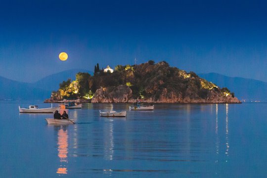 Men on a small boat in Tolo, Greece.