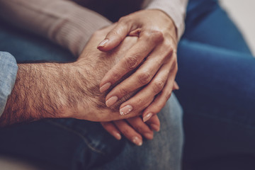 Fototapeta premium True love. Close up of hands of pleasant young couple being held together while expressing her feelings