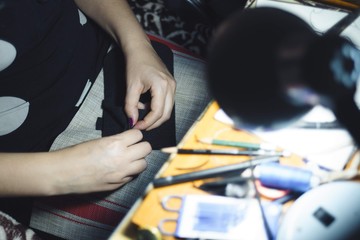 Hands of seamstress at work