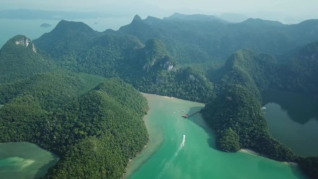 Picturesque tropic island rocks great high Dayang Bunting Lake of Pregnant Maiden.  Langkawi Malaysia Asia Fresh water Rain forest nature landscape Boats ships Landmark. Aerial helicopter