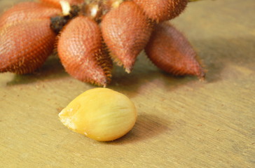 salacca tropical fruit peel out on wooden table