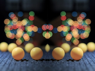Yellow ping pong ball, with bokeh background, on black background
