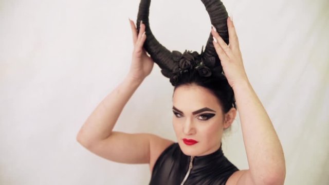 girl in a witch costume with horns