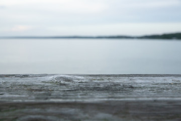 Fototapeta na wymiar Wooden Ledge on Pier with Ocean View in Distance