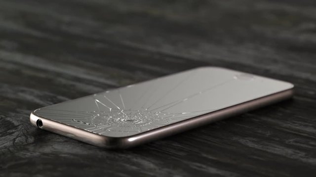 Hammer smashes smartphone in slow motion. Angry destroying mobile technology.