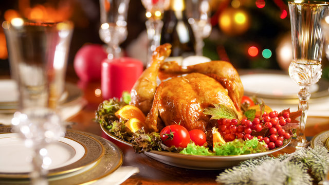 Closeup image of tasty baked chicken on festive table served for Christmas eve