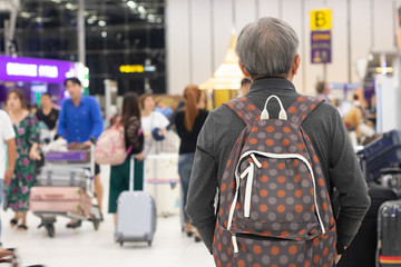 old man at airport travel by airplane