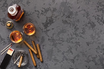 Two glasses with cognac, bottle and cigars