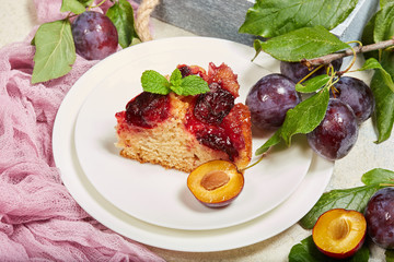 Delicious sponge cake with caramelized plums. Sweet autumn dessert