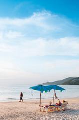 Phuket vibrant Patong beach with colourful umbrellas in evening