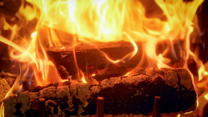 Closeup image of firepalce at house with burning logs