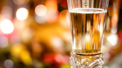 Closeup image of air bubbles floating in champagne against light bokehs