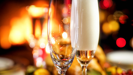Closeup image of two glasses being filled with champagne