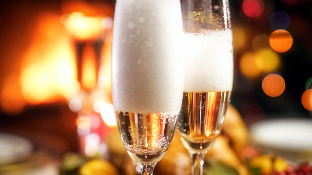 Closeup image of champagne foam settling down in glasses