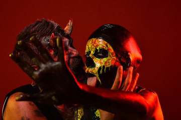 Halloween devil hipster and girl skeleton hug