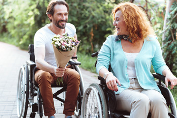 Flowers are always a good idea. Selective focus on a happy mature woman beaming while receiving a bouquet from her thoughtful boyfriend.