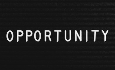 Word opportunity written on the letter board. White letters on the black background
