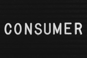 Word consumer written on the letter board. White letters on the black background