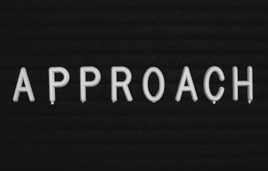 Word approach written on the letter board. White letters on the black background