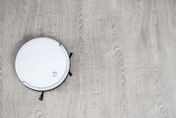Robot vacuum cleaner on laminate floor cleans new cleaning and cleaning technologies