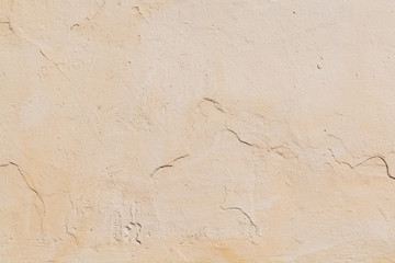 Painted beige concrete wall texture. Light colour sandy background.