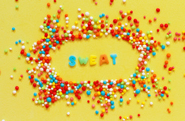 Colorful sugar sprinkles and a word Sweet