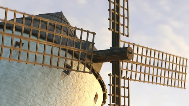 Closeup shot of a vintage Spanish windmill's wings rotating slowly at sunset. 4K
