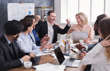 Business people congratulate colleague with his success