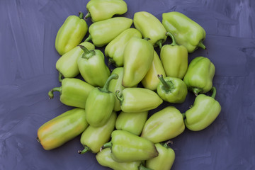 some green bell peppers on grey background