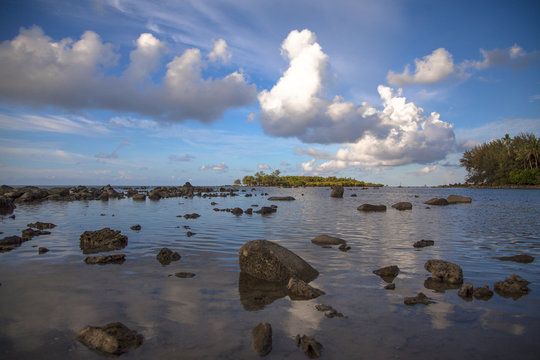 Rocks scattered on the beach with blue sky